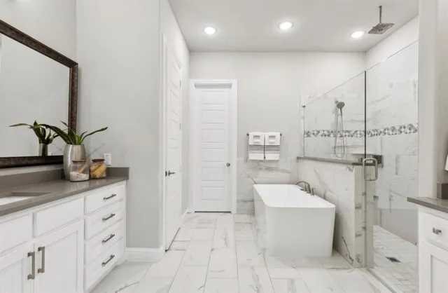 a spacious bathroom with a double vanity sink a mirror and a bathtub