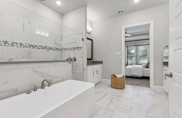 a en suite bathroom with a double vanity sink and a mirror