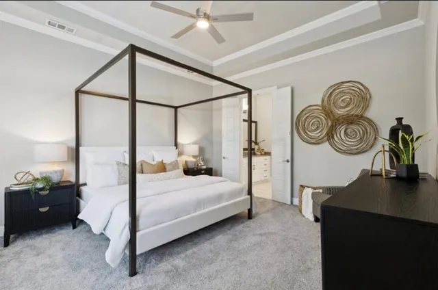 a bedroom with a bed and a chandelier