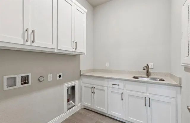 a kitchen with appliances cabinets and a sink