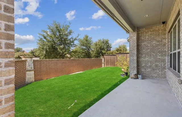 a view of a backyard with plants and a backyard