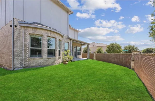 a view of a house with a yard and sitting area