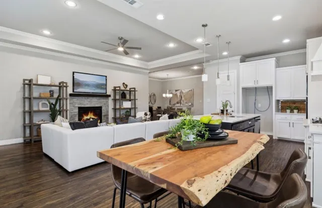 a living room with furniture a fireplace and a flat screen tv