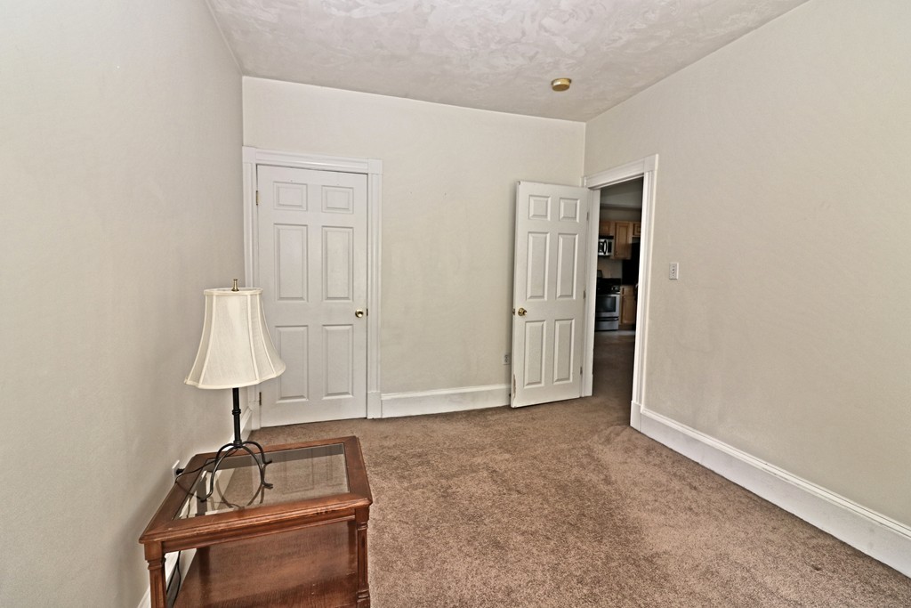 53 Trident Avenue, Unit 103 Winthrop, MA 02152 - Photo 11 of 16 a view of room with window and hardwood floor