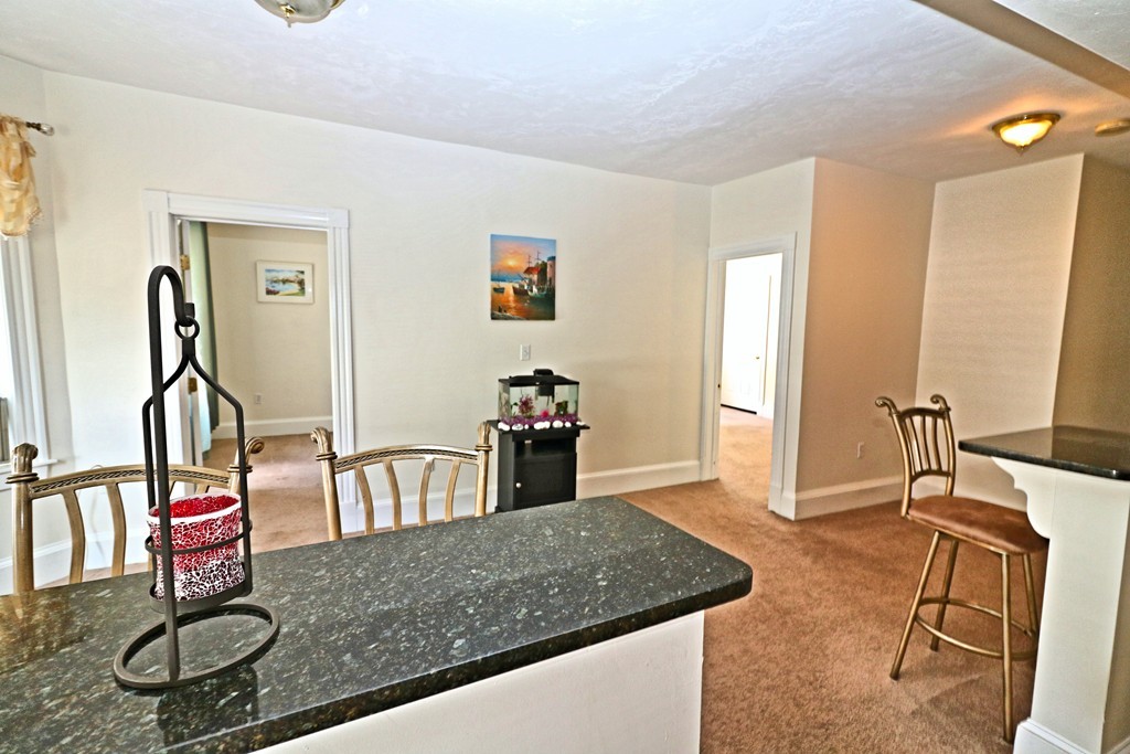 53 Trident Avenue, Unit 103 Winthrop, MA 02152 - Photo 4 of 16 a dining room with table and chairs