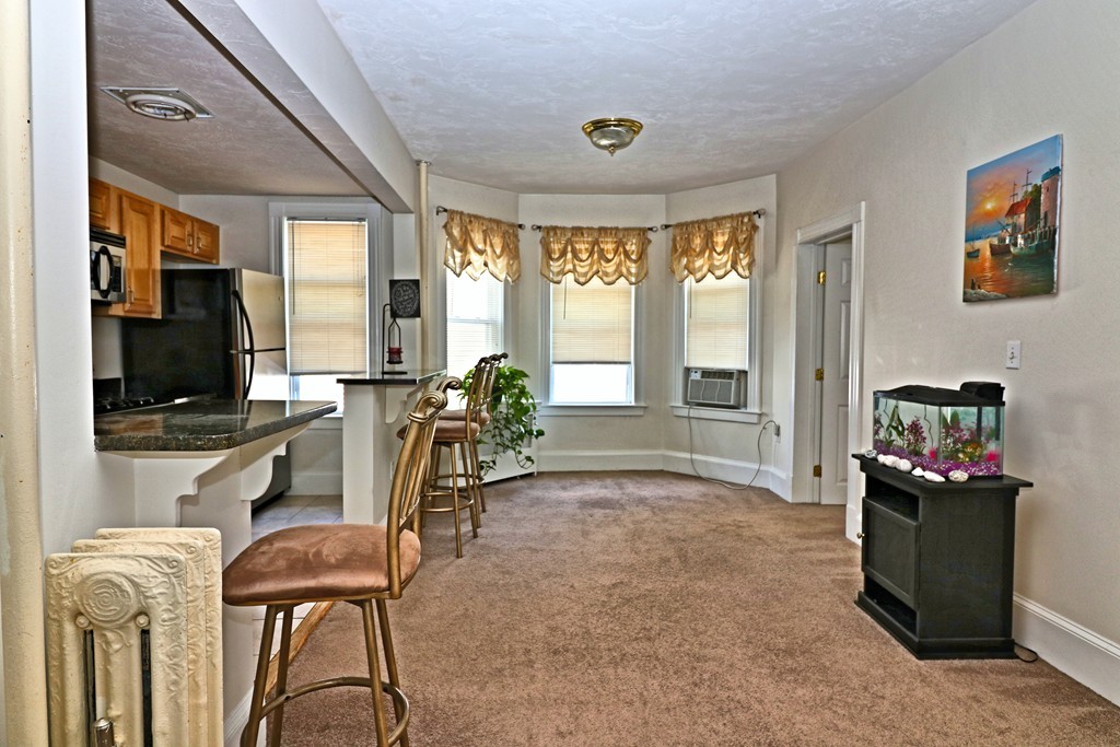 53 Trident Avenue, Unit 103 Winthrop, MA 02152 - Photo 5 of 16 a view of a livingroom with furniture and a flat screen tv