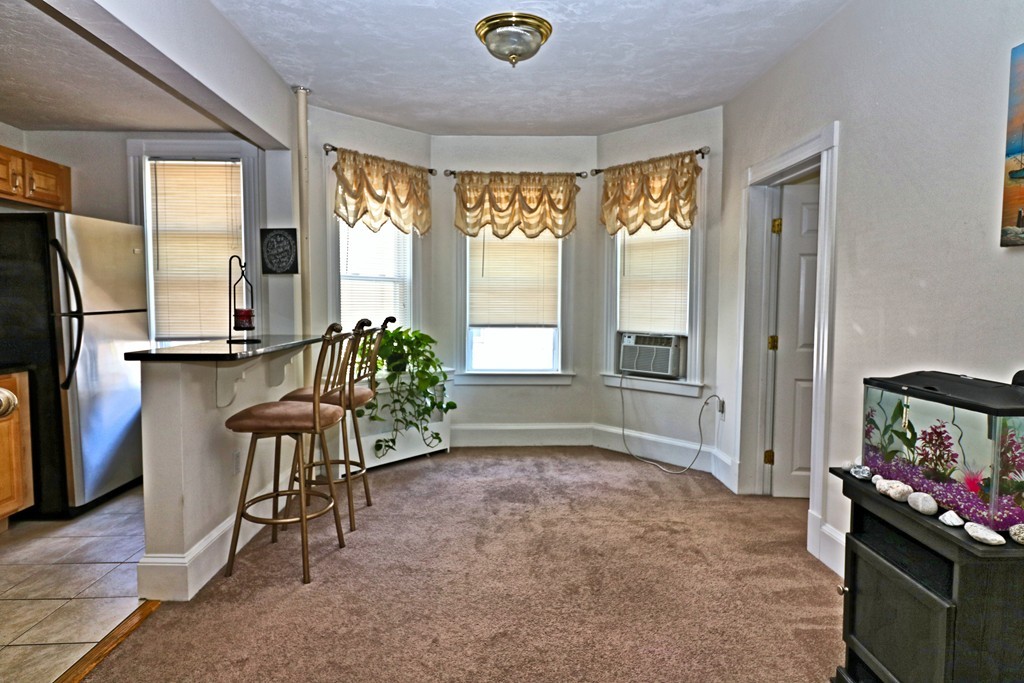 53 Trident Avenue, Unit 103 Winthrop, MA 02152 - Photo 6 of 16 a view of livingroom with furniture and windows