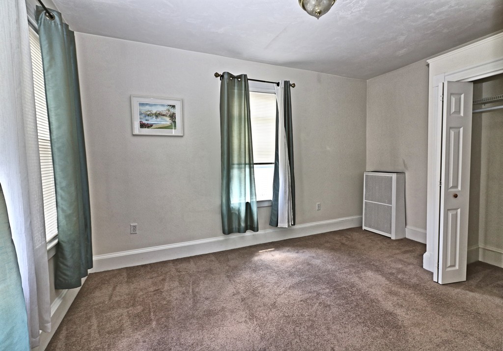 53 Trident Avenue, Unit 103 Winthrop, MA 02152 - Photo 9 of 16 an empty room with windows