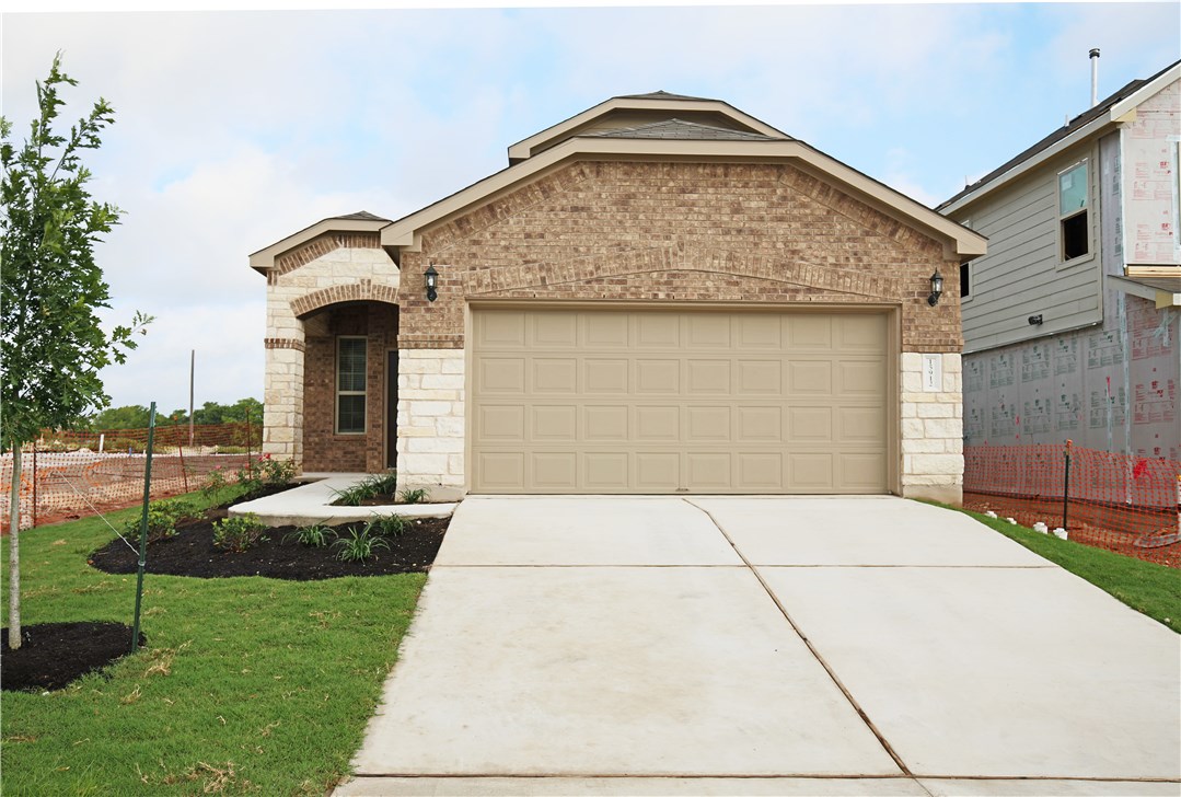 15912 Cessida Street Austin, TX 78728 - Photo 1 of 23 a front view of a house with garden