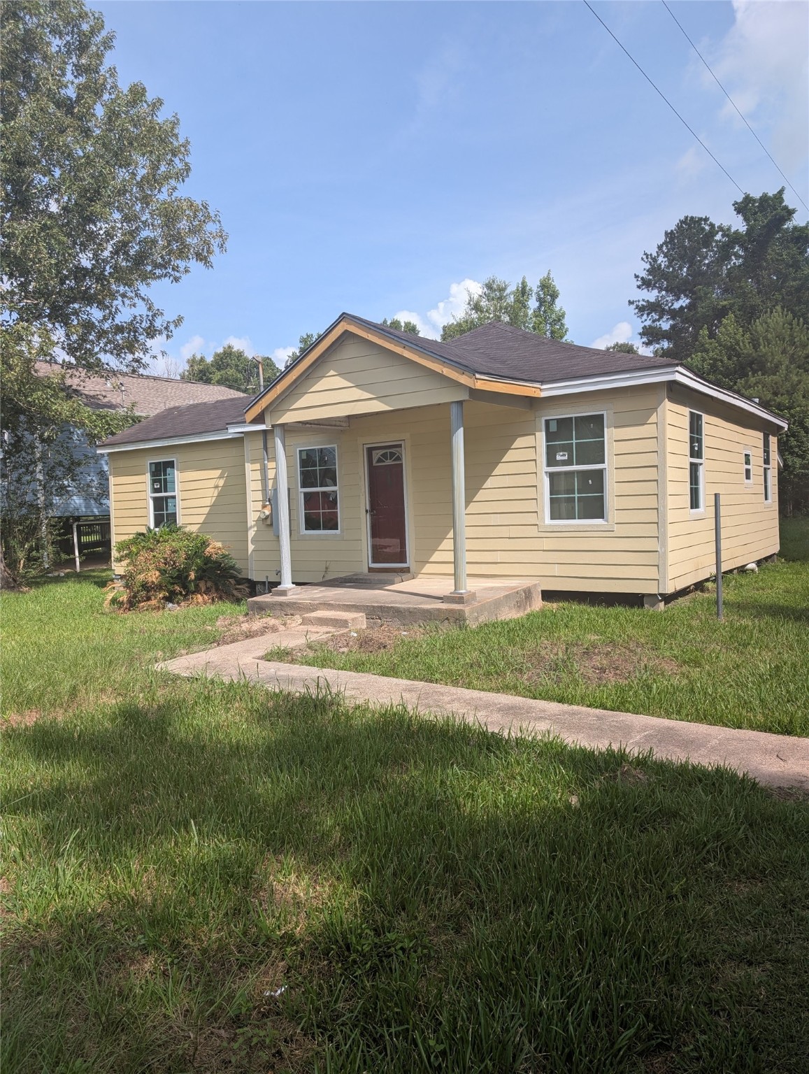 a front view of a house with a garden