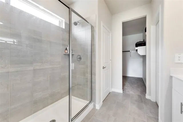a bathroom with a glass shower door