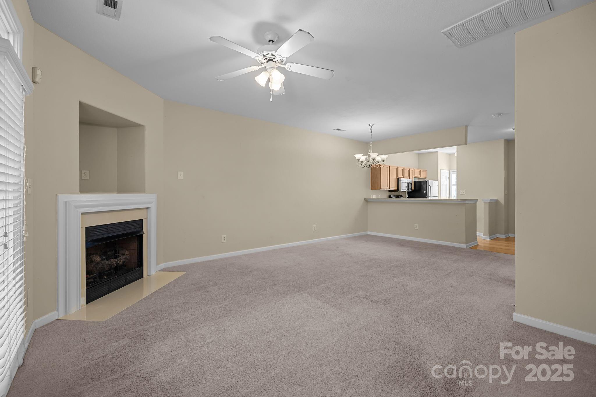 8809 Starnes Randall Road Charlotte, NC 28215 - Photo 12 of 28 a view of a kitchen with a sink and a fireplace