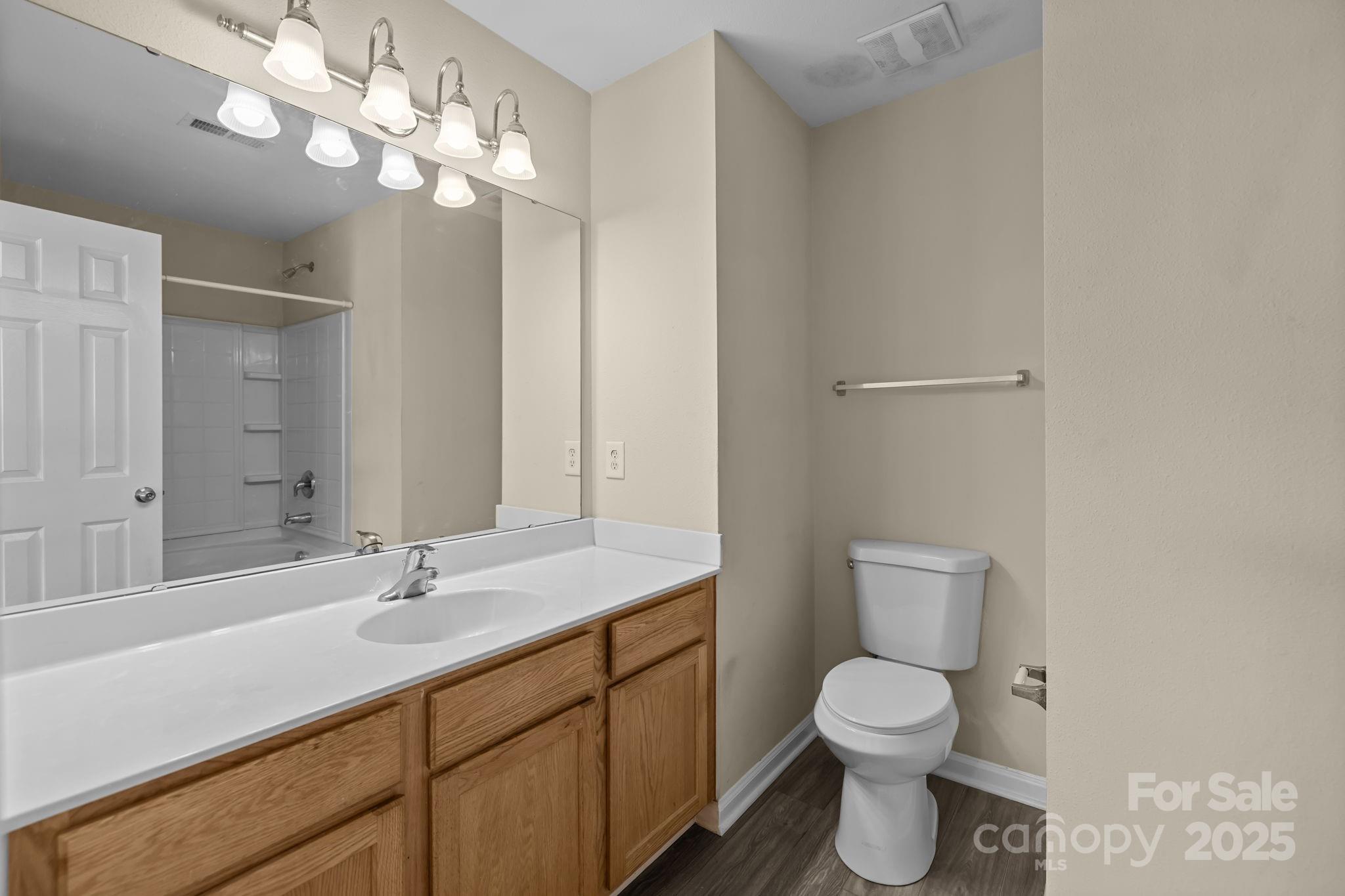 8809 Starnes Randall Road Charlotte, NC 28215 - Photo 16 of 28 a bathroom with a toilet sink and mirror