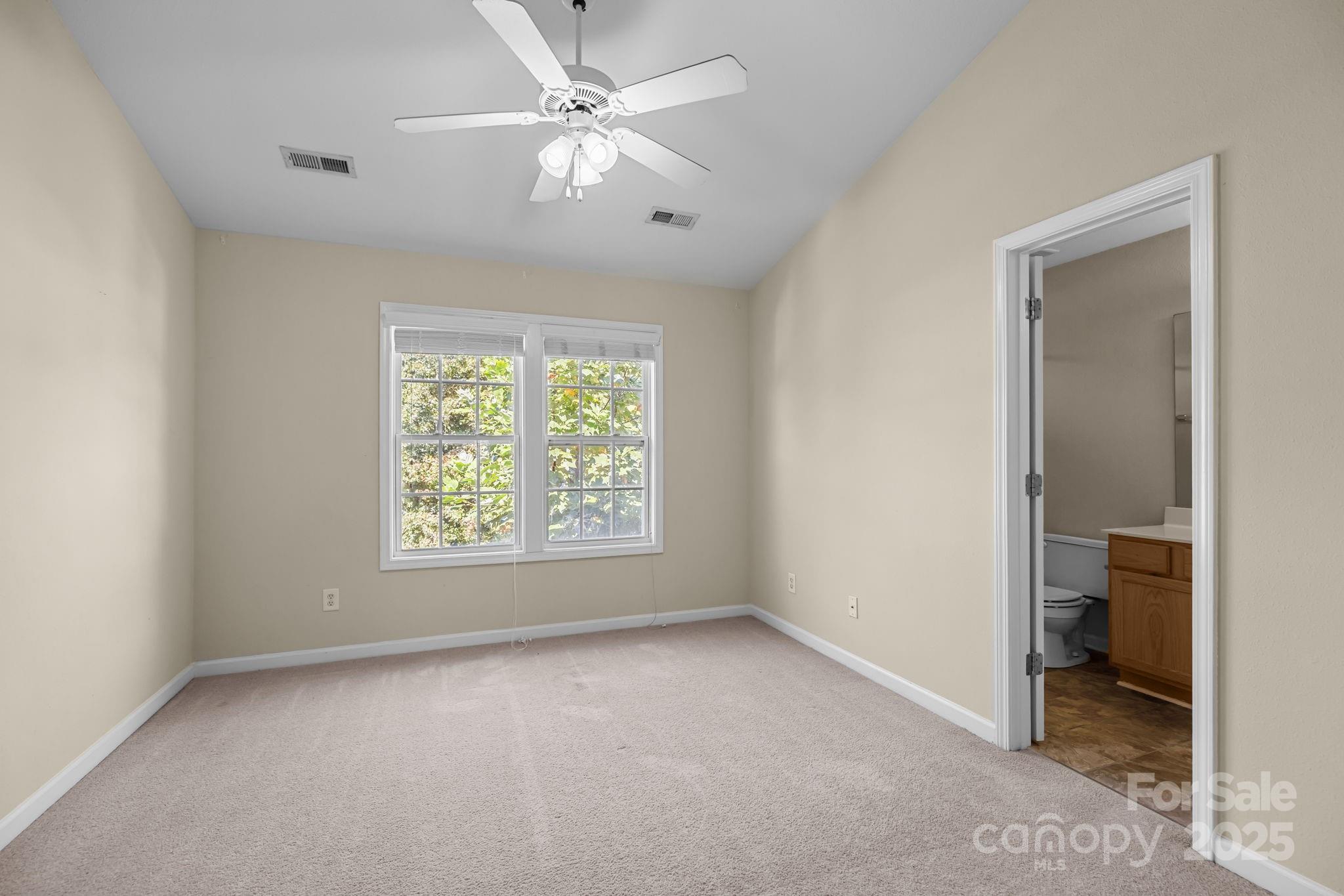 8809 Starnes Randall Road Charlotte, NC 28215 - Photo 17 of 28 a view of a livingroom with a ceiling fan and window