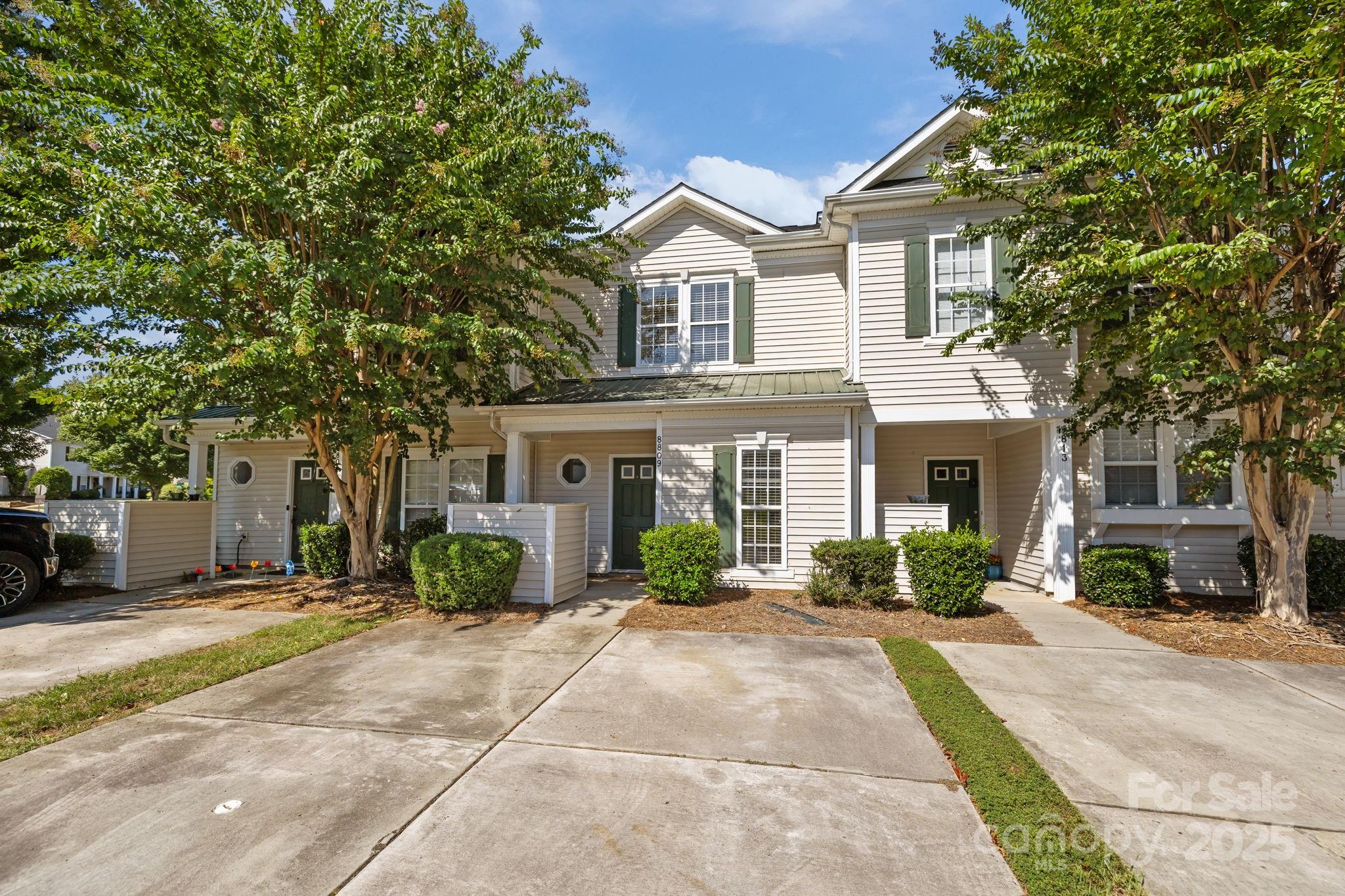 8809 Starnes Randall Road Charlotte, NC 28215 - Photo 24 of 28 a front view of a house with a yard and potted plants