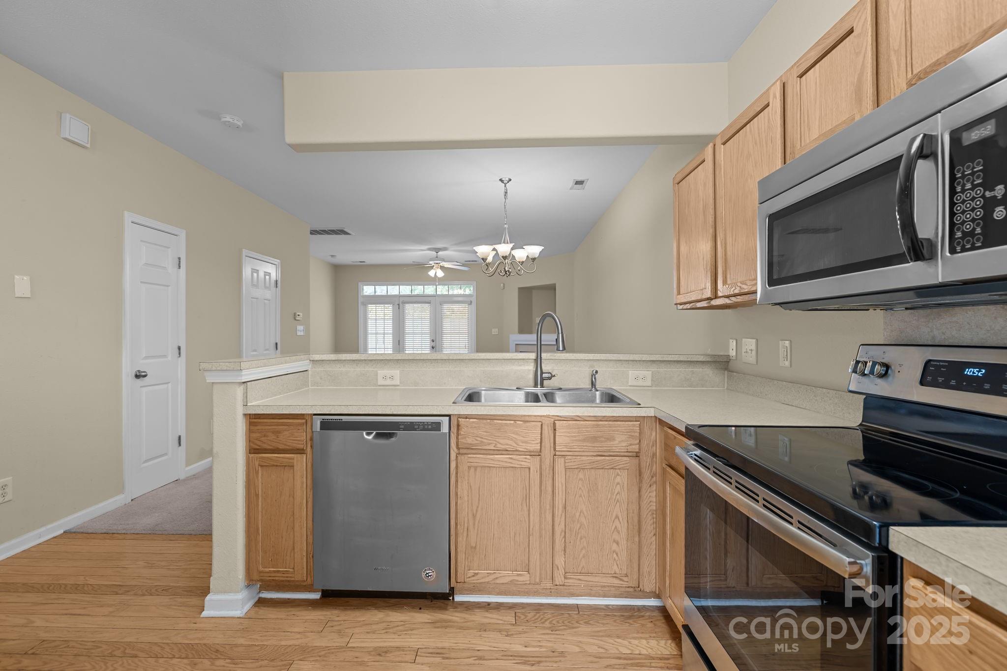 8809 Starnes Randall Road Charlotte, NC 28215 - Photo 7 of 28 a kitchen with stainless steel appliances granite countertop a sink and stove top oven