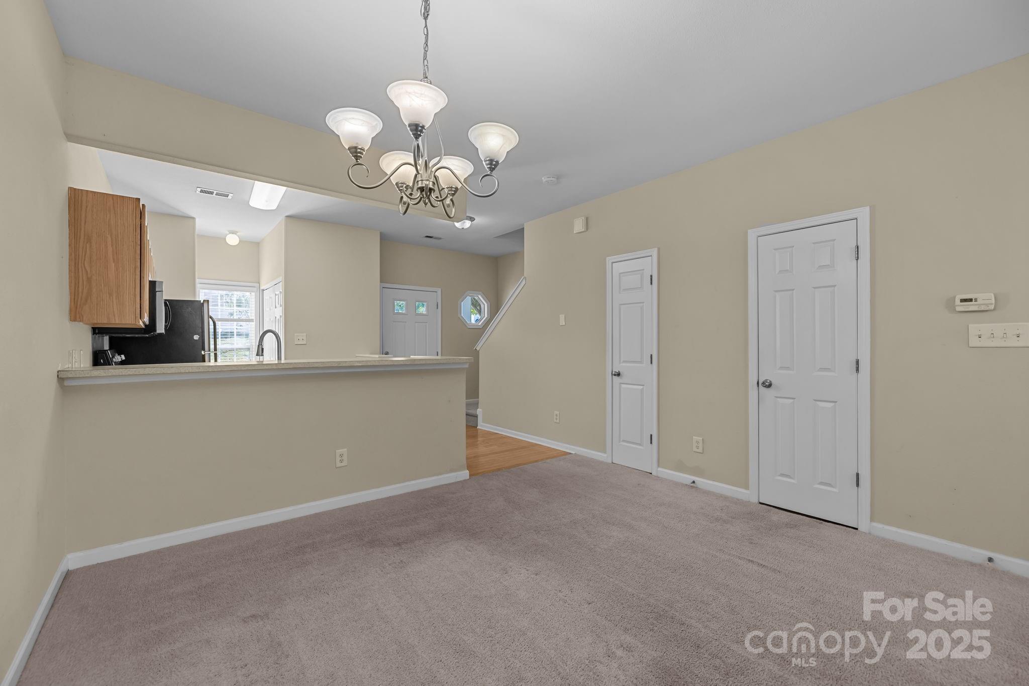 8809 Starnes Randall Road Charlotte, NC 28215 - Photo 8 of 28 a view of a kitchen with a sink a cabinet and a mirror