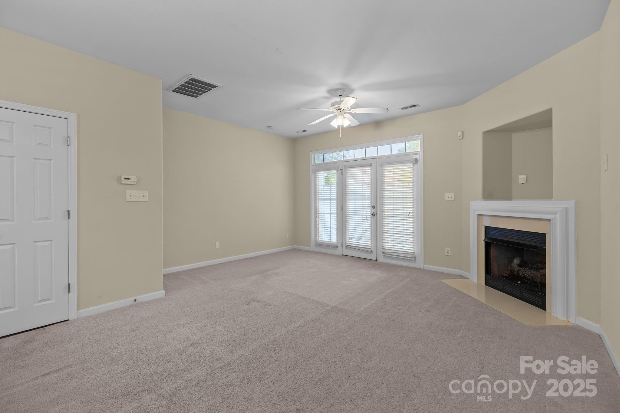 8809 Starnes Randall Road Charlotte, NC 28215 - Photo 10 of 28 a view of empty room with fireplace ceiling fan
