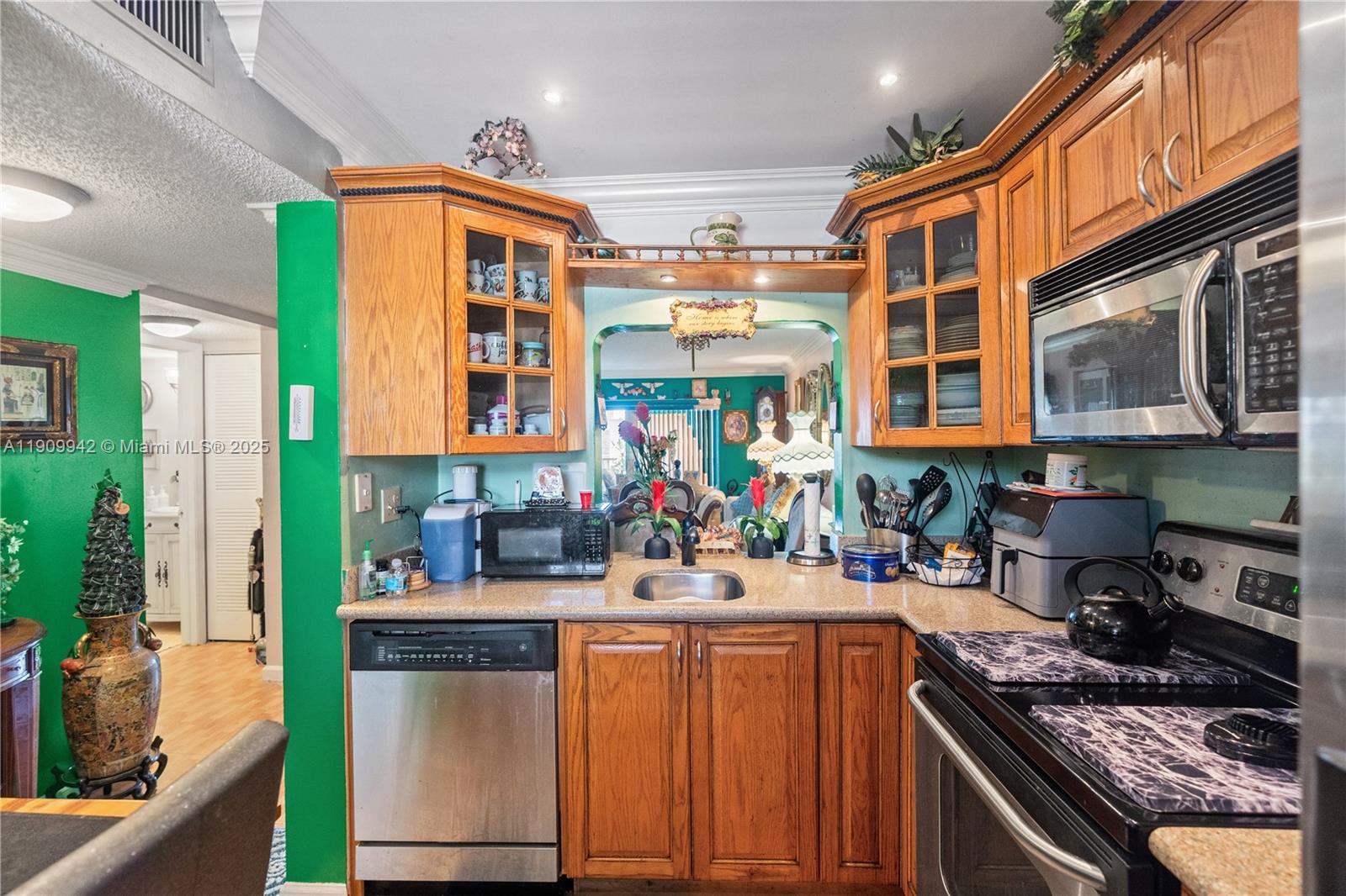 3199 Foxcroft Road, Unit 314 Miramar, FL 33025 - Photo 4 of 25 a kitchen that has a lot of cabinets in it