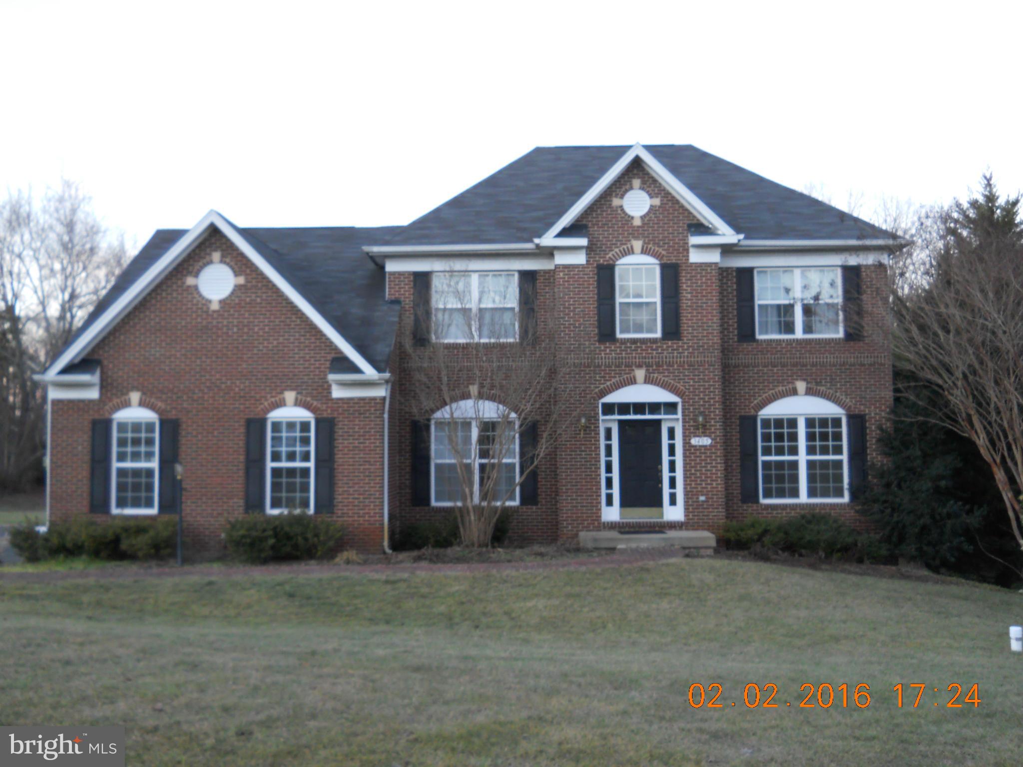 3405 Evans Road Huntingtown, MD 20639 - Photo 1 of 16 a front view of a house with a yard