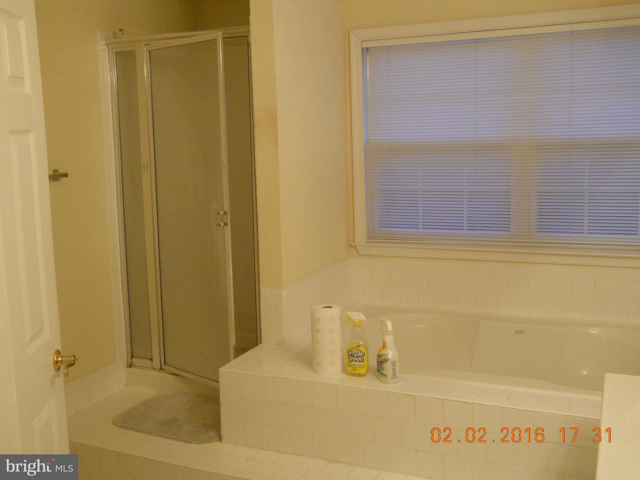 3405 Evans Road Huntingtown, MD 20639 - Photo 13 of 16 a bathroom with a bathtub