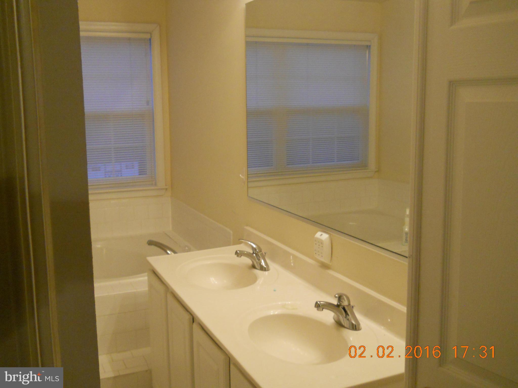 3405 Evans Road Huntingtown, MD 20639 - Photo 14 of 16 a bathroom with a sink and a mirror