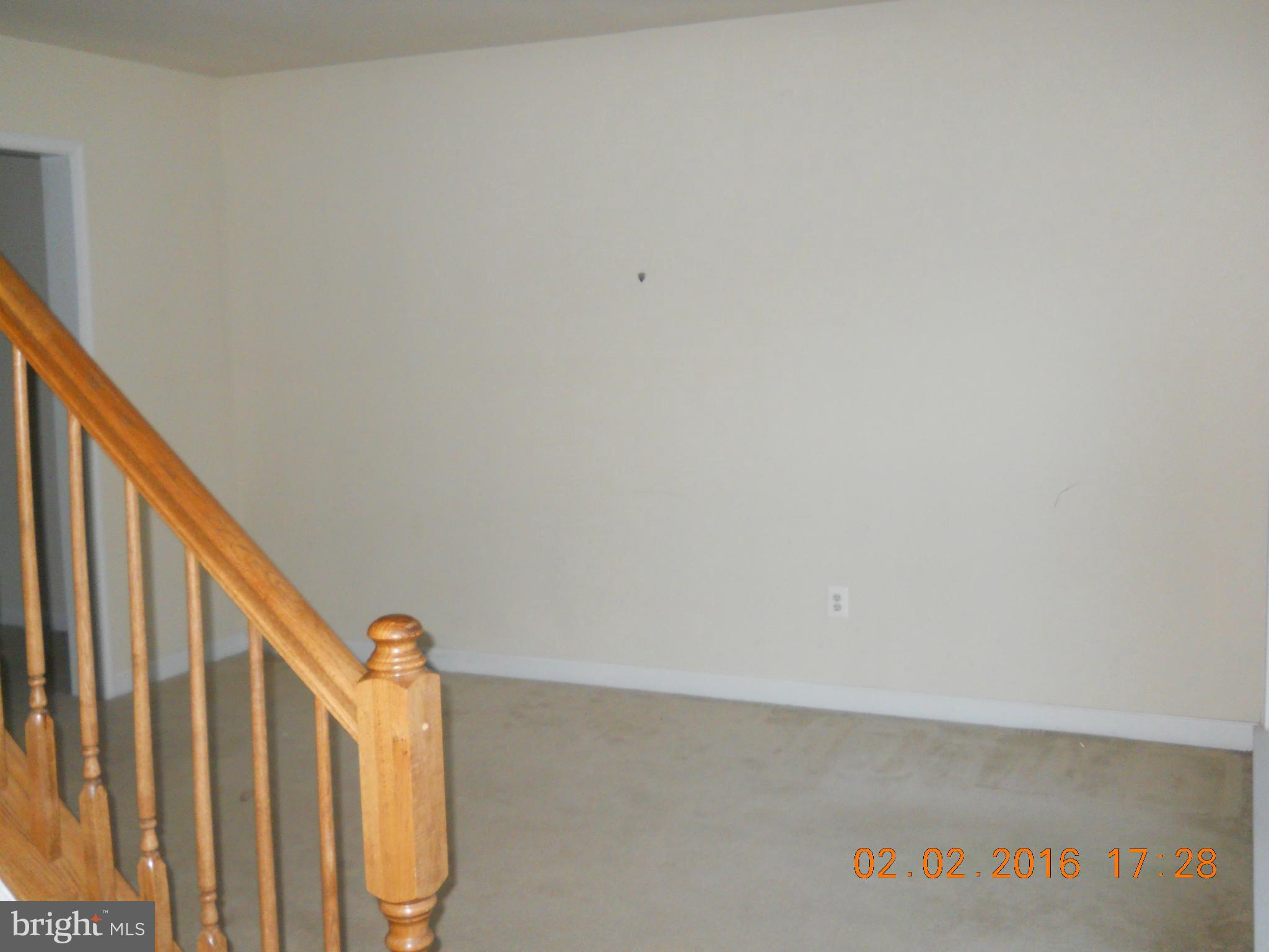 3405 Evans Road Huntingtown, MD 20639 - Photo 4 of 16 a view of staircase with railing and a window