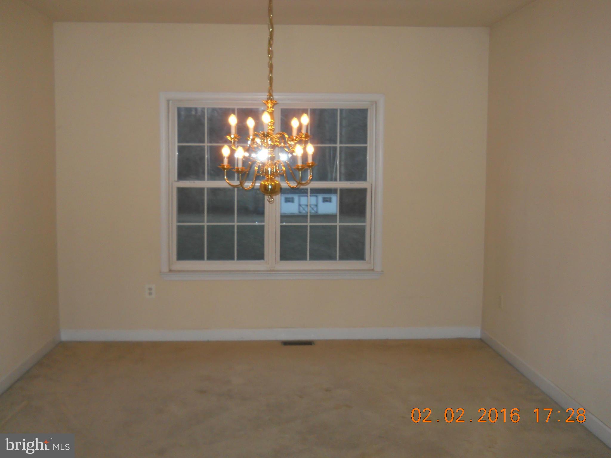 3405 Evans Road Huntingtown, MD 20639 - Photo 5 of 16 a view of an empty room with a window