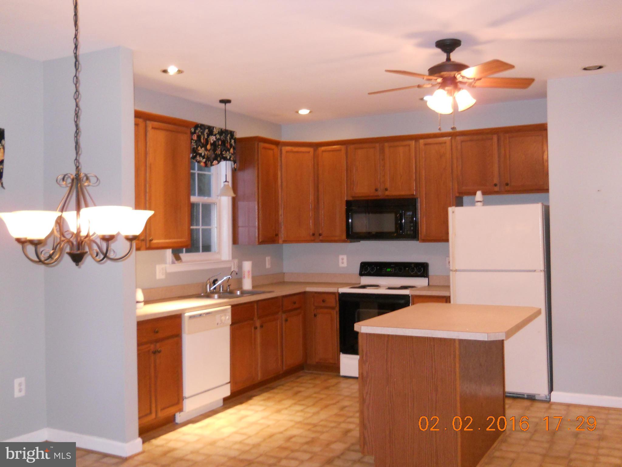 3405 Evans Road Huntingtown, MD 20639 - Photo 6 of 16 a kitchen with a sink cabinets and appliances