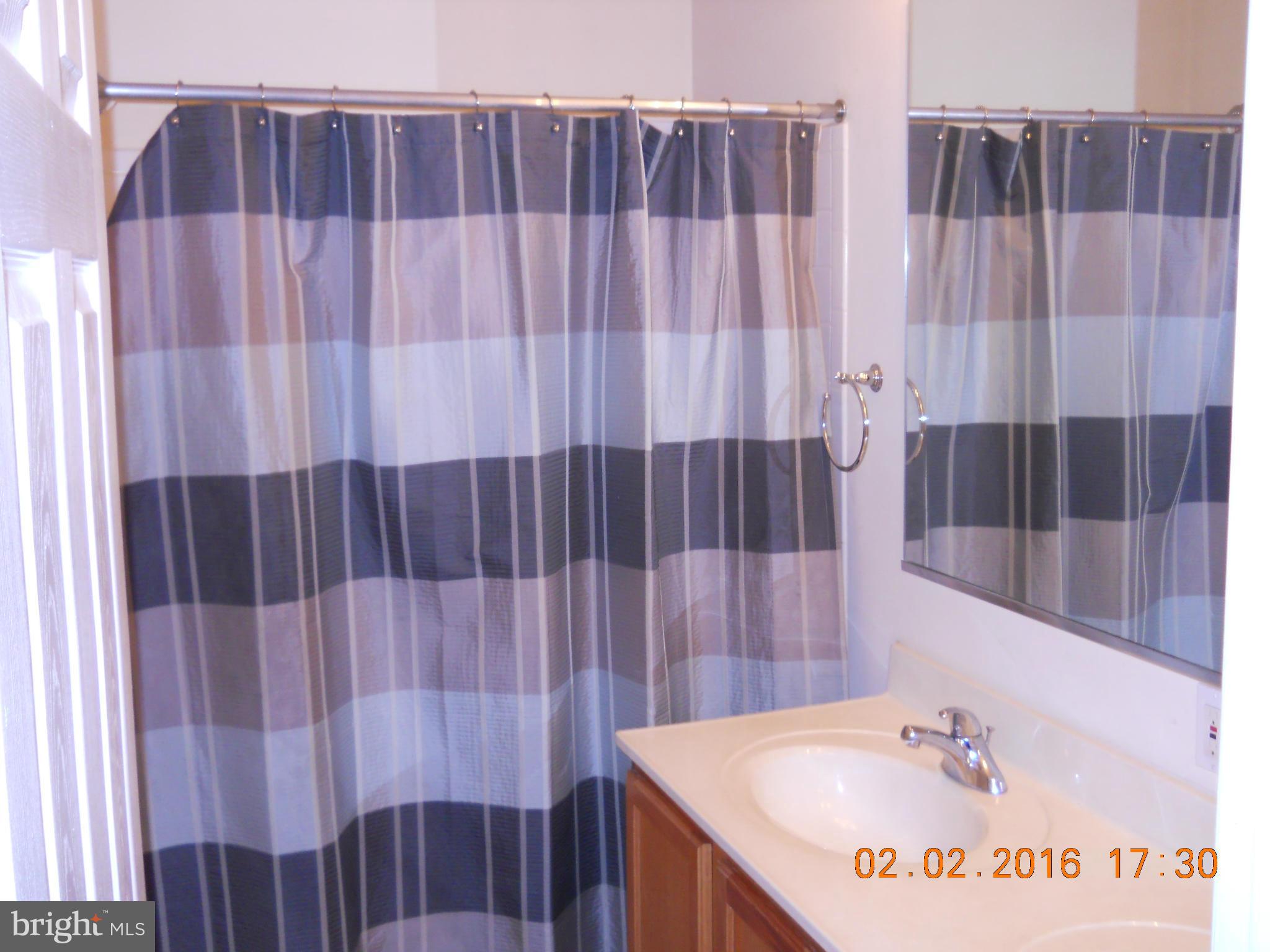 3405 Evans Road Huntingtown, MD 20639 - Photo 8 of 16 a bathroom with a sink and a mirror