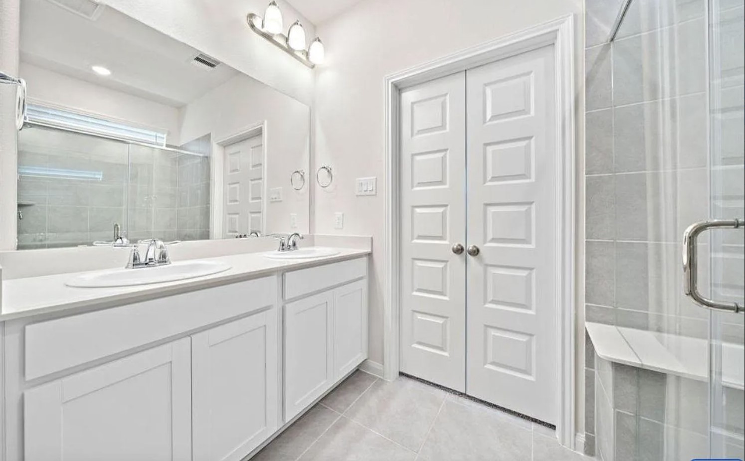 5631 Giving Grace Way Houston, TX 77048 - Photo 5 of 10 a bathroom with a double vanity sink a mirror and a shower