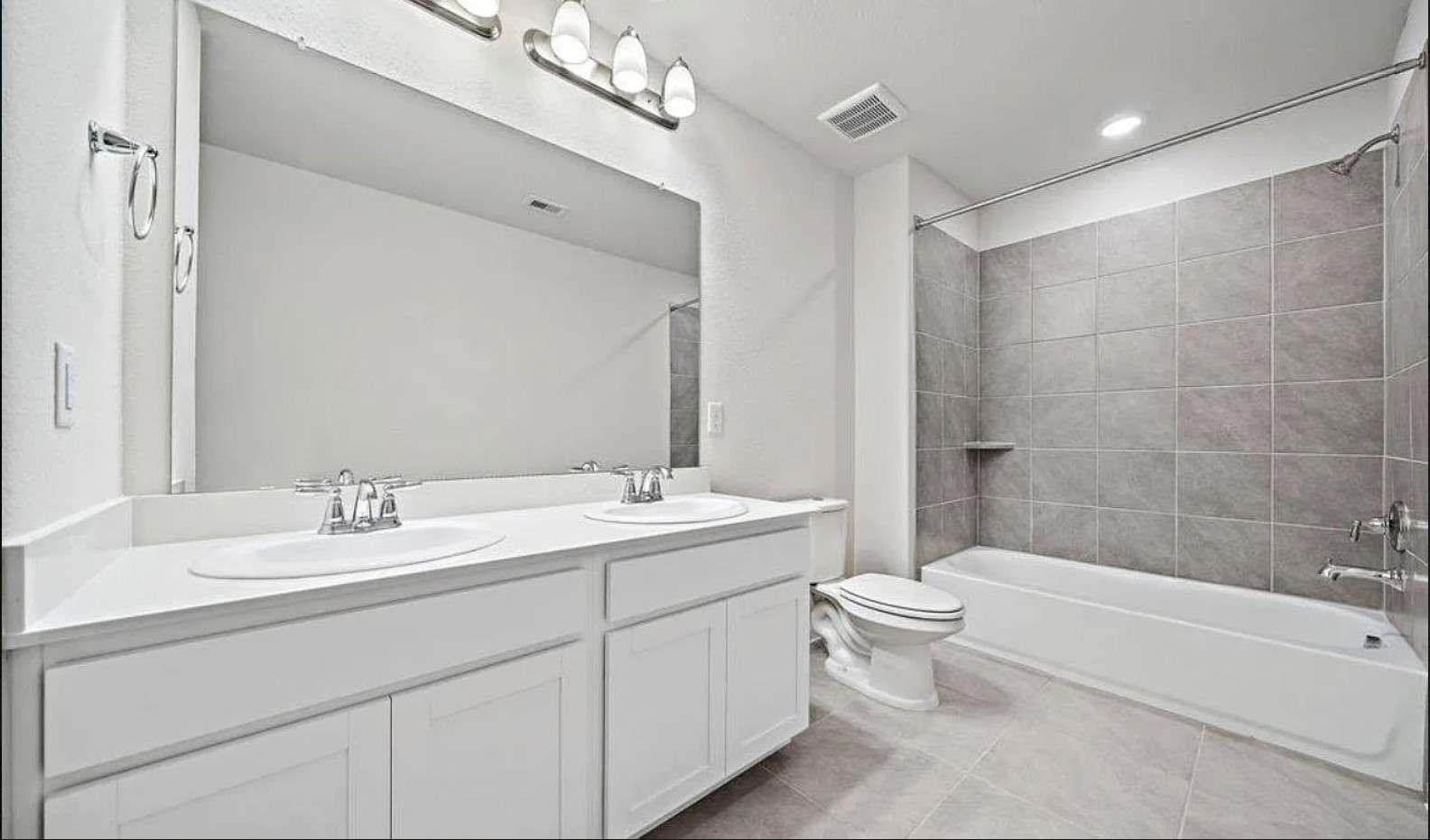 5631 Giving Grace Way Houston, TX 77048 - Photo 9 of 10 a bathroom with a double vanity sink toilet mirror and bathtub