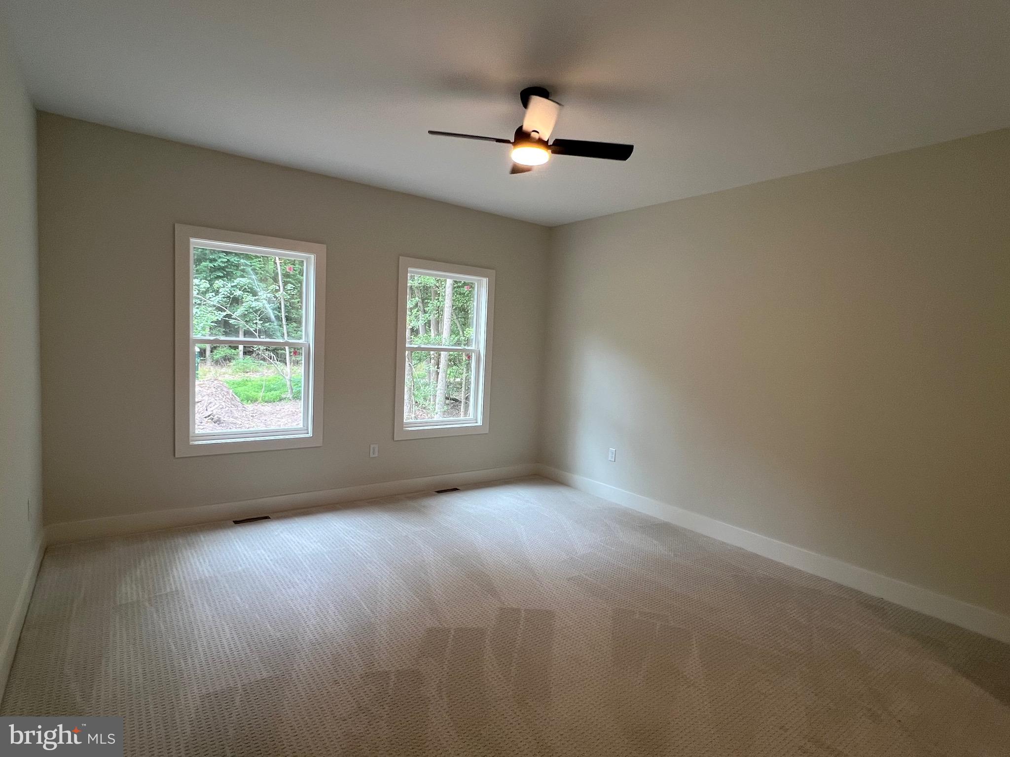 175 Rose Way Colonial Beach, VA 22443 - Photo 4 of 33 an empty room with windows and fan