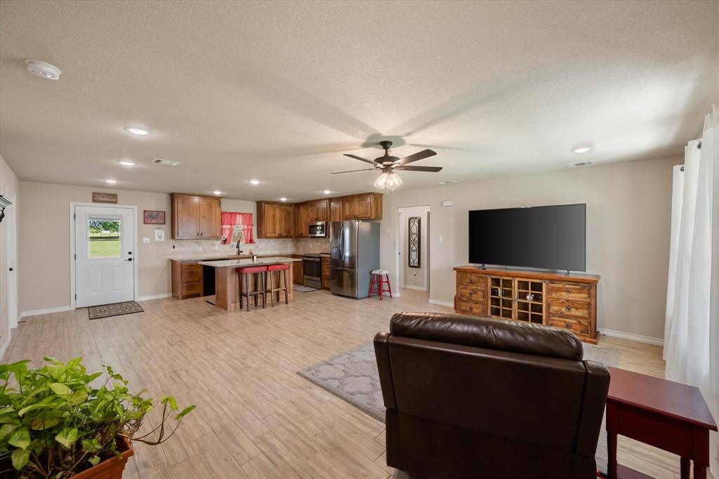 2004 Brown Loop Poolville, TX 76487 - Photo 14 of 36 a living room with furniture and a flat screen tv