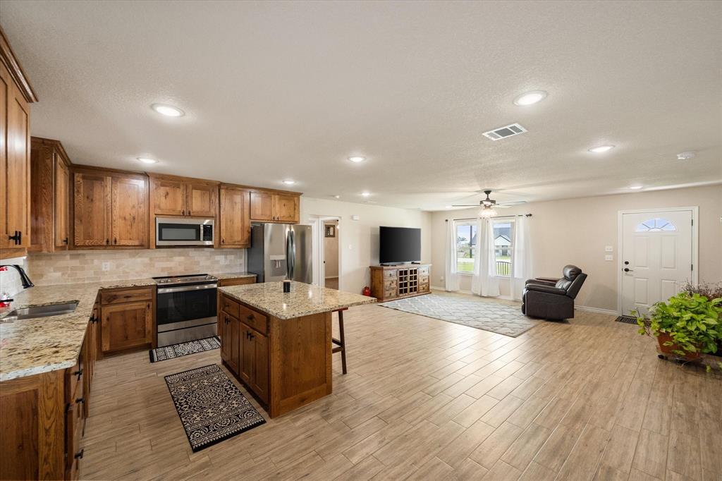 2004 Brown Loop Poolville, TX 76487 - Photo 21 of 36 a kitchen with sink refrigerator and microwave