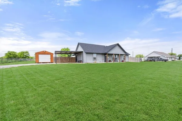 an aerial view of a house with a big yard