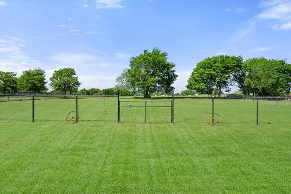 an aerial view of a residential houses with yard