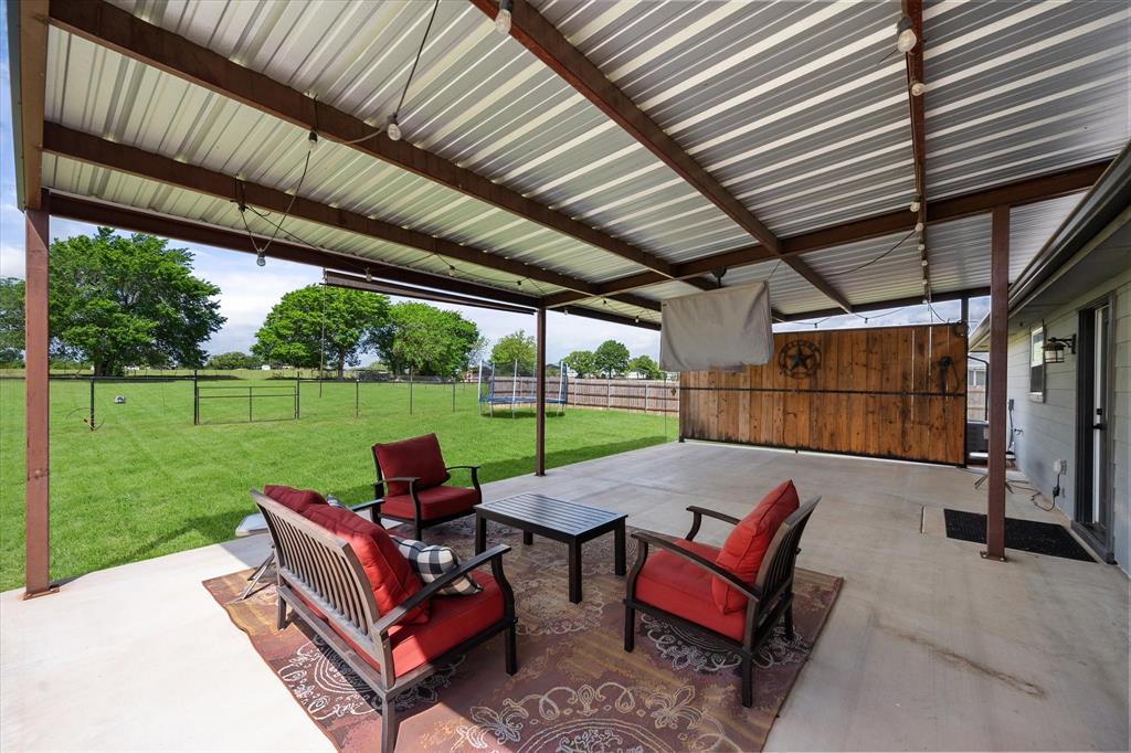 2004 Brown Loop Poolville, TX 76487 - Photo 10 of 36 a view of a patio with couches chairs and a yard
