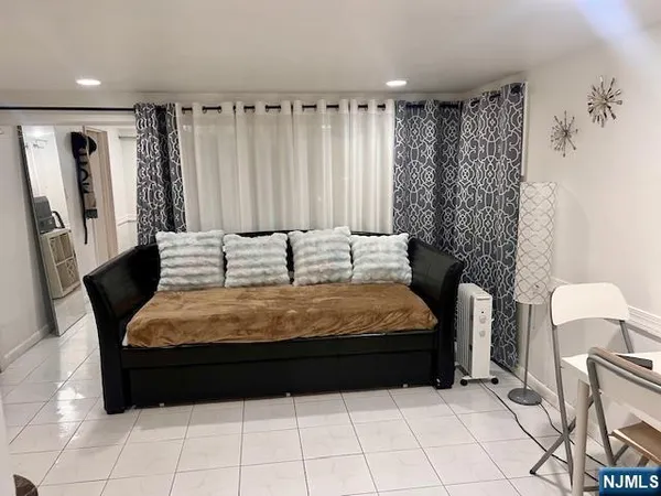 a bedroom with a bed and a chair