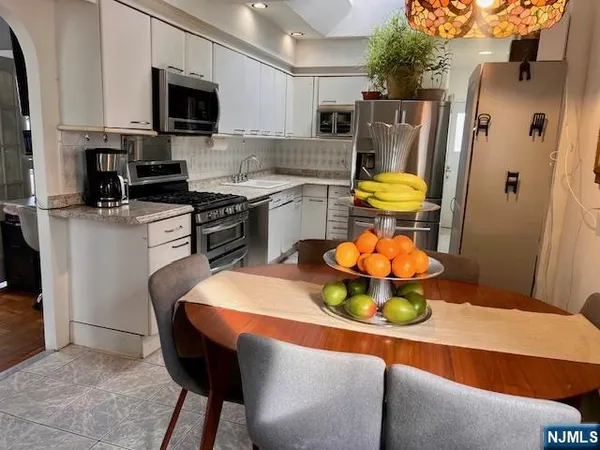 a kitchen with stainless steel appliances a stove a sink and a microwave