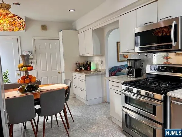 a kitchen with a stove a sink and a refrigerator