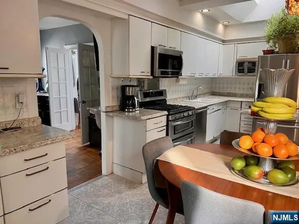 a kitchen with a sink appliances and cabinets