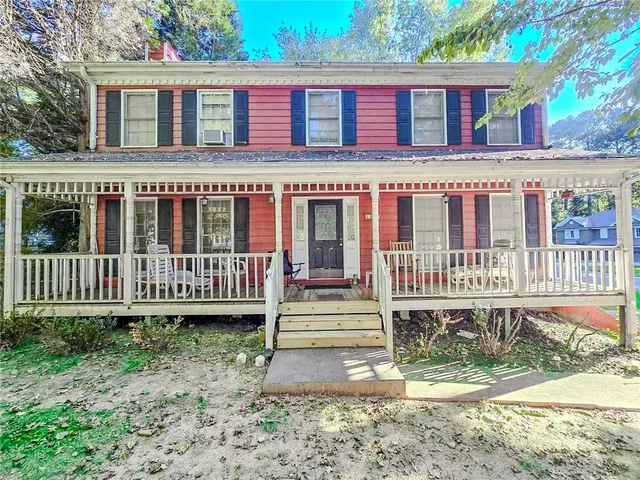 a view of a house with a yard and fence