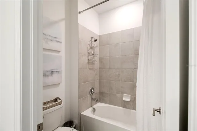 a bedroom with a bed and a lamp