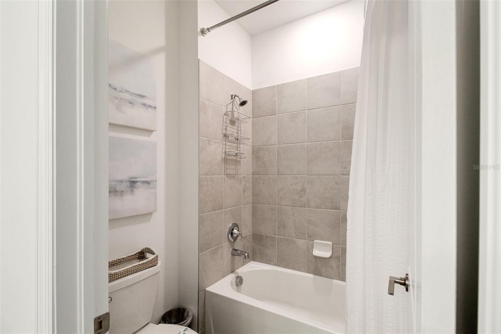 15025 Sea Salt Way Bradenton, FL 34211 - Photo 11 of 64 a bathroom with a bathtub and a shower