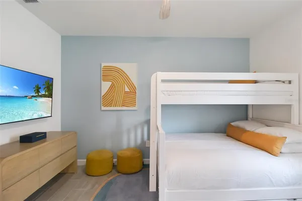 a hallway with wooden floor and a bathroom
