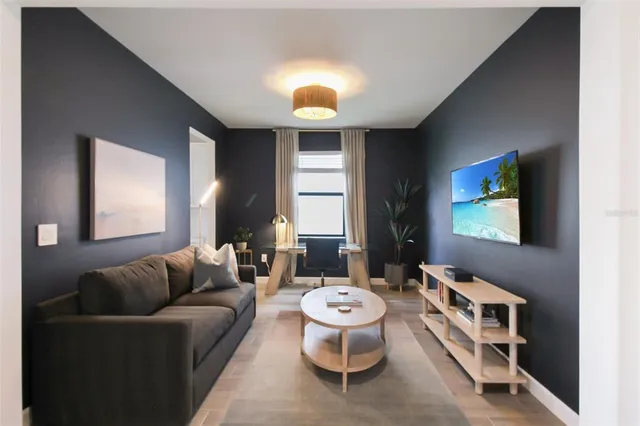 a living room with furniture and a large window