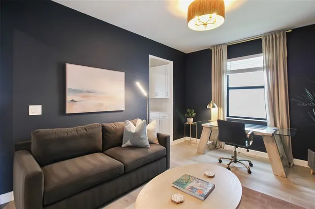 a living room with furniture and a large window