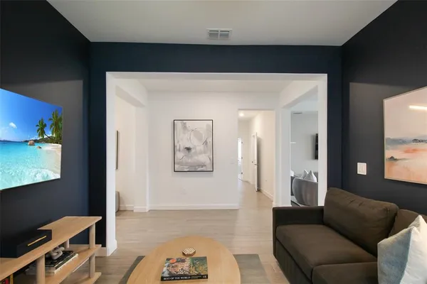 a living room with furniture and a chandelier