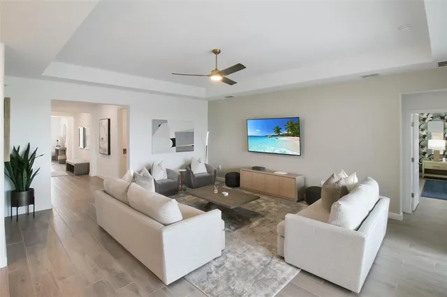 a kitchen with a sink a stove a refrigerator and white cabinets